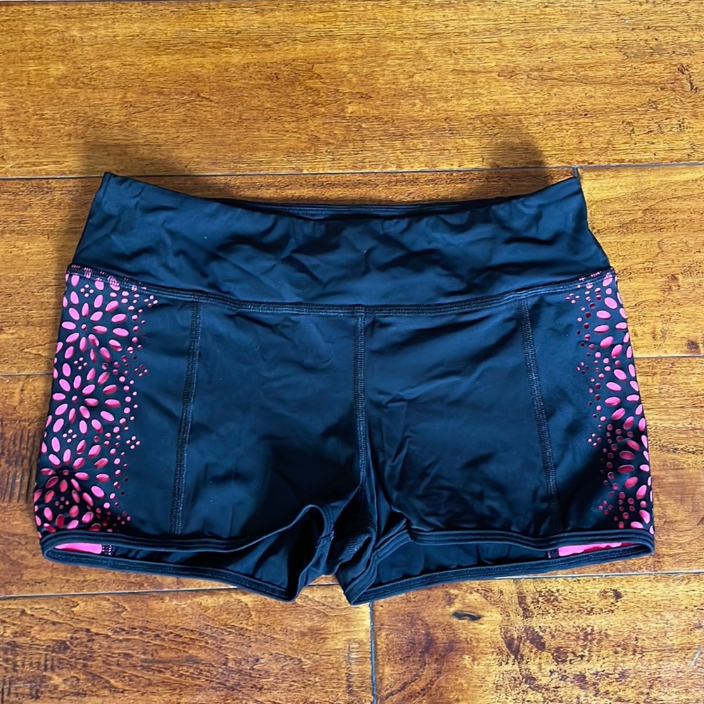 Les Dance shorts. Black with melon/pink cutout floral design on sides. Size 12